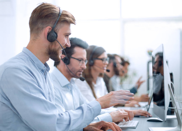 handsome man with a headset working in a call center - Foto, imagen