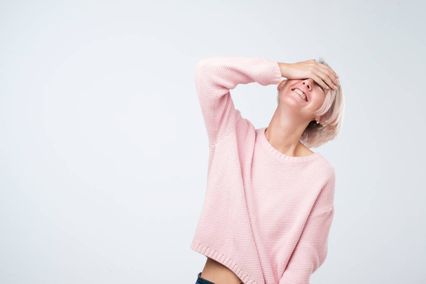 Laughing woman in pink sweater. It is very funny joke - Photo, Image