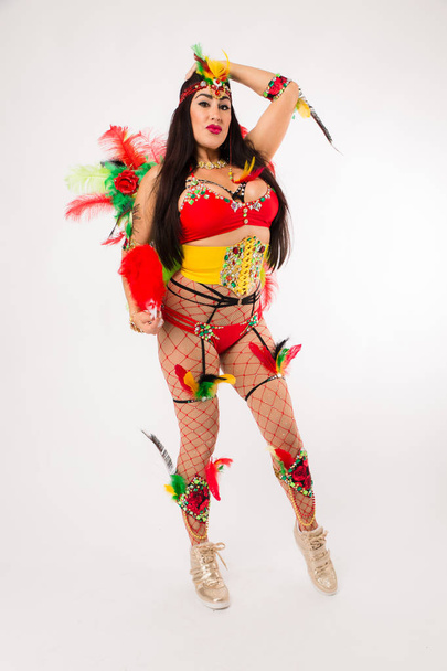 Dark haired hispanic woman in Carnaval costume and athletic shoes posing on clean white background - Photo, Image