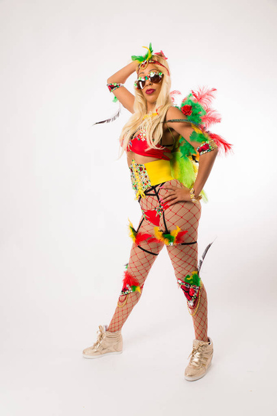 Tall blonde black woman in Carnaval costume and athletic shoes posing on clean white background - Fotó, kép