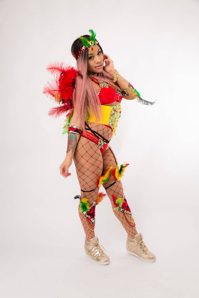 Fit young asian woman in Carnaval costume and athletic shoes posing on clean white background - Foto, immagini