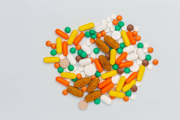 drug pills and capsules of different color and shape on white - Photo, image
