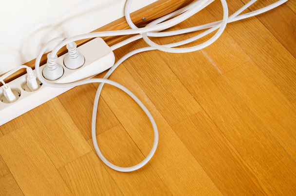 Multiple socket and plugs on wooden floor. - Photo, Image