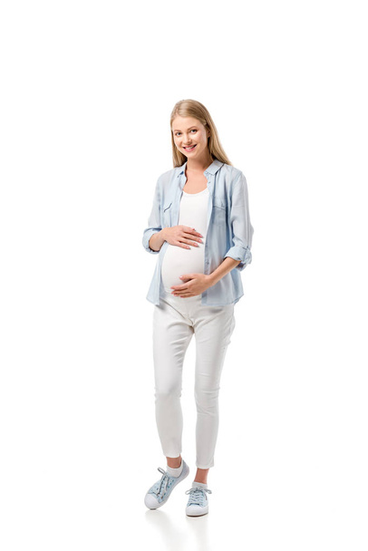 attractive pregnant woman in casual clothes looking at camera isolated on white - Valokuva, kuva