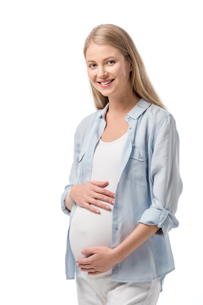attractive smiling pregnant woman in casual clothes looking at camera isolated on white - Фото, изображение