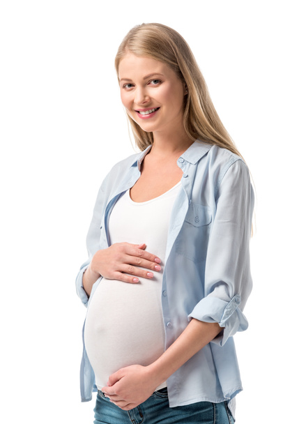 happy pregnant woman in casual clothes looking at camera isolated on white - Fotó, kép