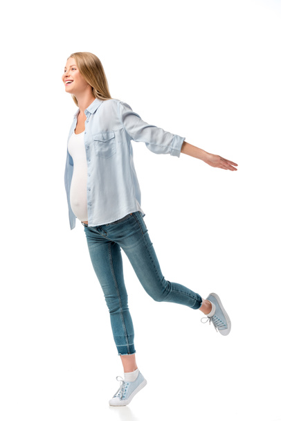 happy beautiful pregnant woman in shirt and jeans isolated on white - 写真・画像