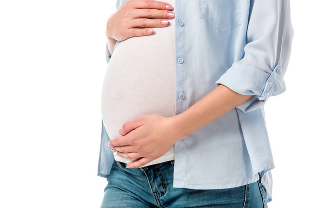 cropped shot of pregnant woman touching tummy with hands isolated on white - Fotó, kép