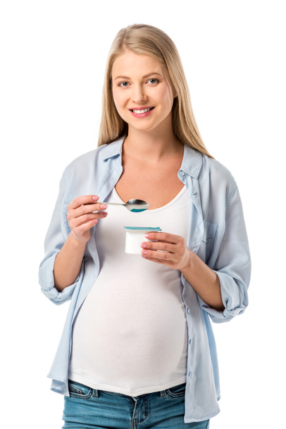 happy pregnant woman eating yogurt isolated on white - Foto, afbeelding