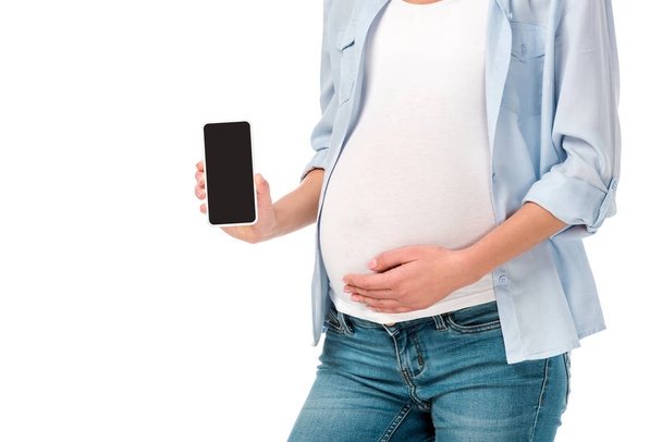 vista cortada de mulher grávida apresentando smartphone com tela em branco isolado no branco
 - Foto, Imagem