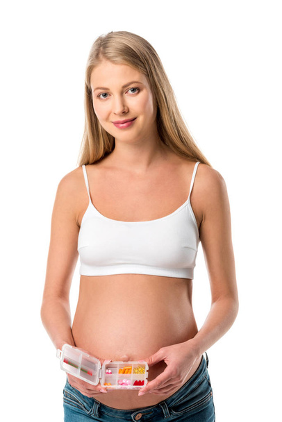 bela mulher grávida segurando caixa pílula com vitaminas isoladas no branco
 - Foto, Imagem
