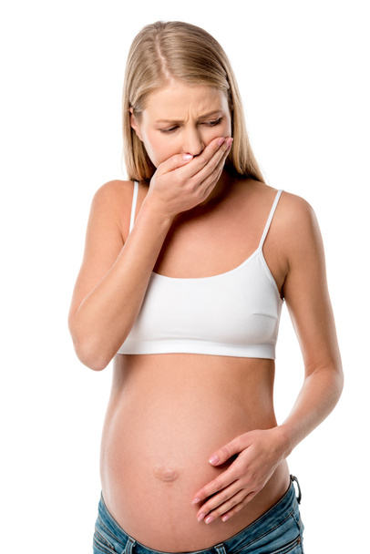 беременная женщина в белом лифчике с тошнотой изолированы на белом
 - Фото, изображение