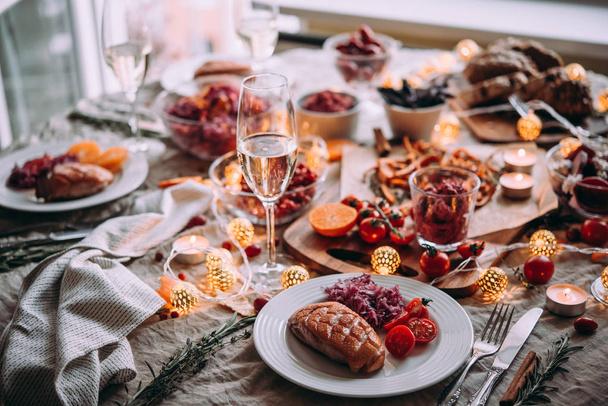 Healthy modern vegetable dishes and roasted turkey or duck. Dinner table, celebrating Christmas or New Year eve. - 写真・画像