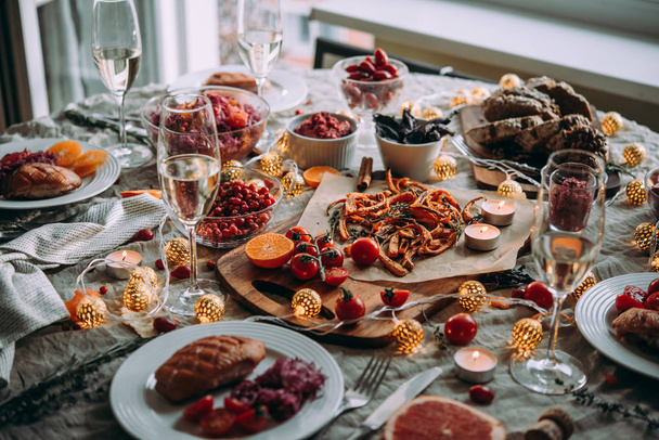 Dinner table, celebrating Christmas or New Year eve. Healthy modern vegetable dishes and roasted turkey or duck - Foto, Imagen