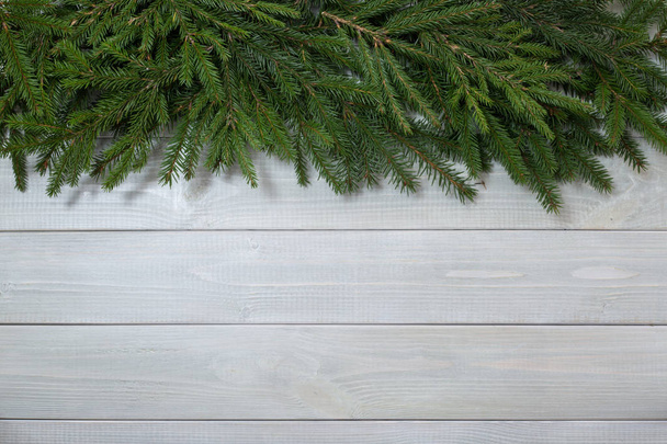 Fundo de Natal com ramos de abeto em branco tonificado prancha de madeira natural fundo textura provence estilo para espaço de cópia para texto
 - Foto, Imagem