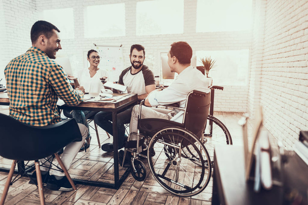 Young Workers Have Discussion in Modern Office. Brainstorm at Work. Smiling Woman. Man on Wheelchair. Smiling Manager. Teamwork in Office. Plan Presentation. Communication with Colleagues. - Fotoğraf, Görsel