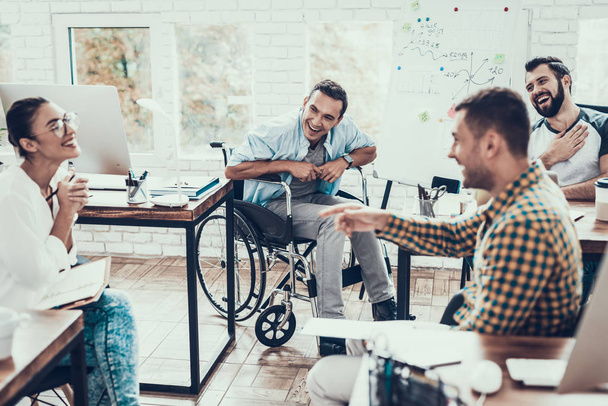 Young Workers Have Discussion in Modern Office. Brainstorm at Work. Smiling Woman. Man on Wheelchair. Smiling Manager. Teamwork in Office. Plan Presentation. Communication with Colleagues. - Fotó, kép