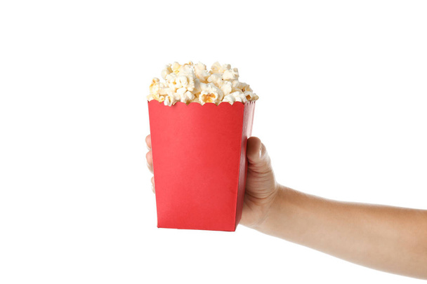Woman holding bucket with delicious popcorn on white background, closeup - Fotografie, Obrázek