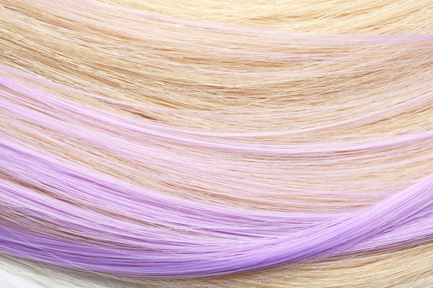 Strands of blond and violet hair as background, closeup - Photo, Image