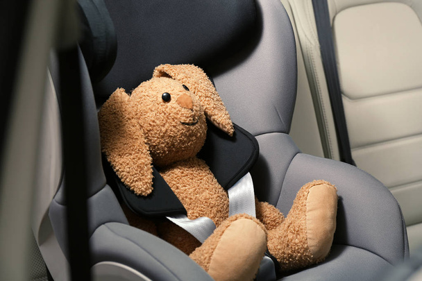 Safety seat for baby with cute toy rabbit - Fotó, kép