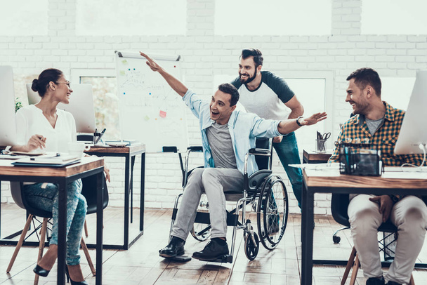 Happy Workers Have Fun on Break in Modern Office. Smiling Woman. Man on Wheelchair. Smiling Manager. Communication with Colleagues. Fun in Office. Teamwork Concept. Manager in Office. - Φωτογραφία, εικόνα