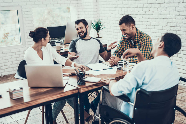 Young Workers Have Discussion in Modern Office. Brainstorm at Work. Smiling Woman. Man on Wheelchair. Smiling Manager. Teamwork in Office. Plan Presentation. Communication with Colleagues. - Foto, imagen