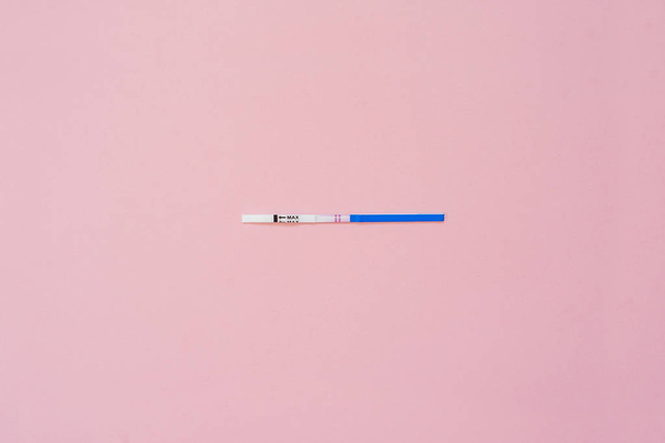 Pregnancy test isolated on pink background. Positive result.  - Fotó, kép