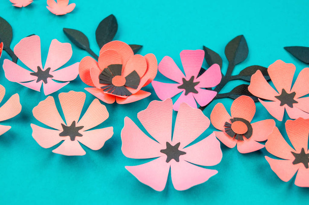 Flower and leaves made of paper on a turquoise background. Handwork, favorite hobby. Pink black and blue color. - Foto, immagini