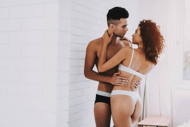 Young Beautiful Couple in Underwear in Bedroom. Handsome Man and Attractive Woman in Love. Passionate Romantic Couple about to have Sex at Home. Passion, Intimate Relationship and Love Concept - Photo, image