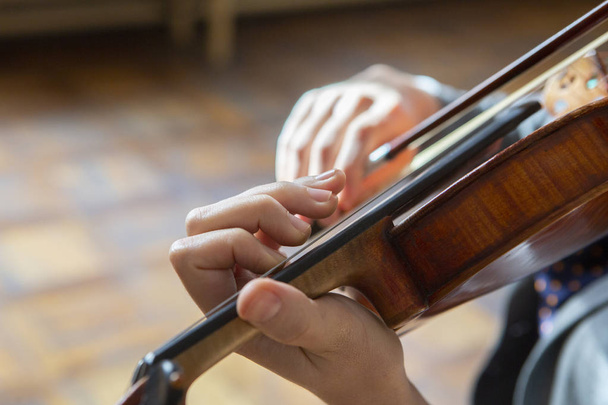 Hand on the strings of a violin Close-up - Zdjęcie, obraz