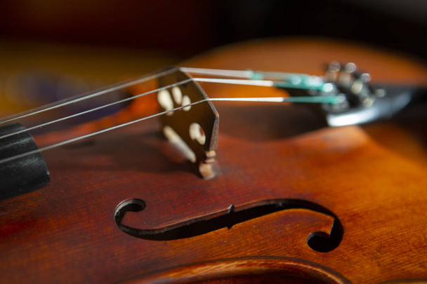 violin in vintage style on wood background close up, classical music concert - 写真・画像
