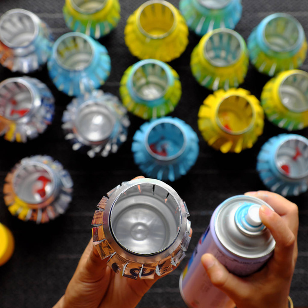 Woman hand recycling cans of beer by cut and spray paint to make lantern for mid autumn festival - Photo, Image