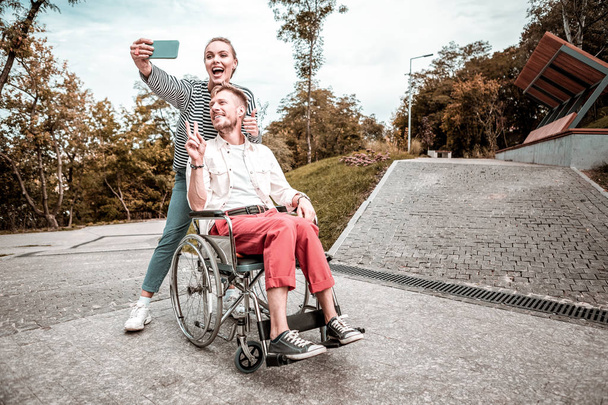 Cute couple making funny faces while taking selfies - Fotografie, Obrázek