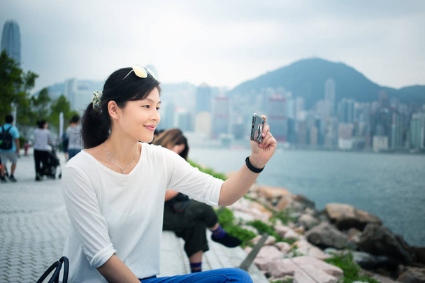 Asian woman using smartphone in Hong Kong city - Fotografie, Obrázek