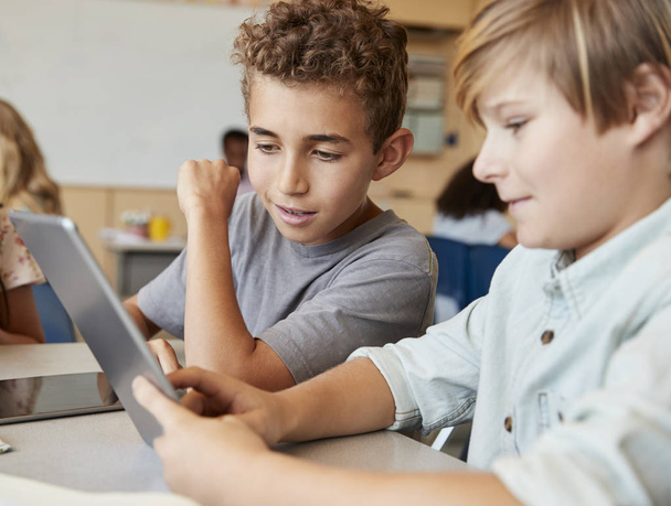 Schoolboys working together with tablet computer - Φωτογραφία, εικόνα