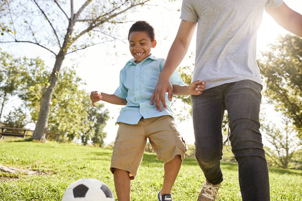 Father And Son Playing Soccer In Park Together  - Foto, Bild