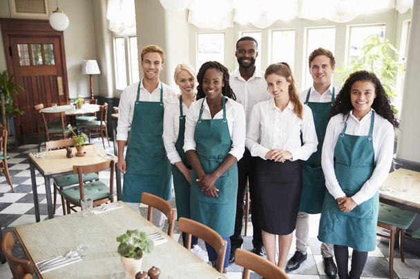 Portrait Of Restaurant Team Standing In Empty Dining Room - Foto, imagen