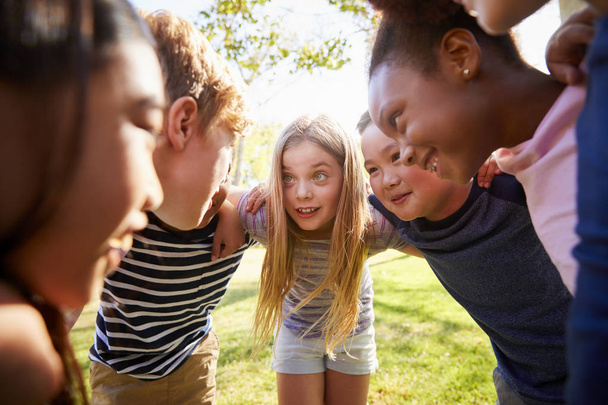 Multi-ethnic group of kids embracing, looking at each other - Photo, Image