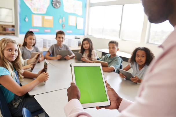 Teacher and kids using tablets in elementary school lesson - Fotó, kép