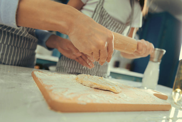 View of womans hands making dough with daughter - Foto, Bild