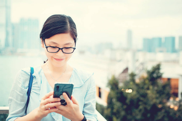 Young woman using smartphone in City - Photo, Image
