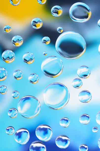 close-up view of beautiful calm clean water drops on light blurred background  - Foto, imagen