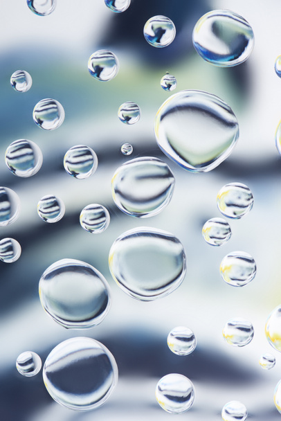 close-up view of beautiful transparent water drops on light blurred background - Fotografie, Obrázek