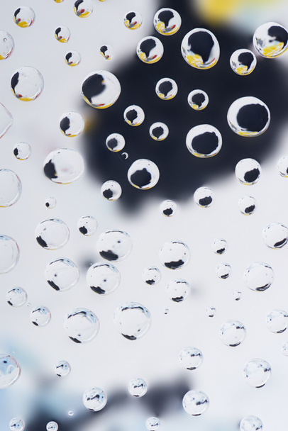 close-up view of beautiful transparent droplets on blurred abstract background - Valokuva, kuva