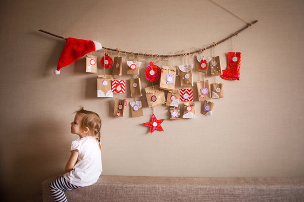 the advent calendar hanging on the wall. small gifts surprises for children. - Foto, Bild