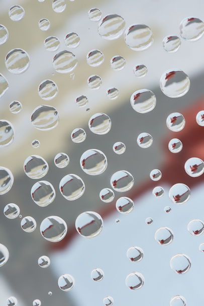 close-up view of transparent droplets on blurred abstract background - Foto, Imagen