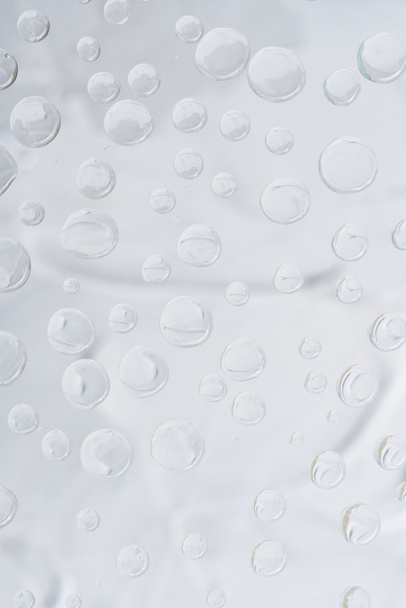 close-up view of transparent dew drops on grey abstract background - Photo, image