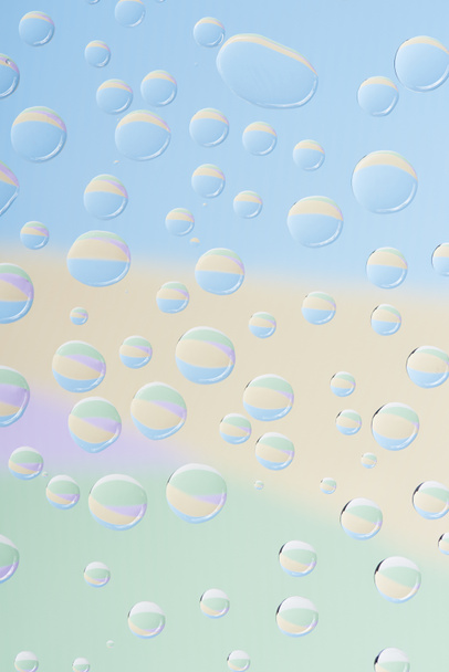 close-up view of transparent rain drops on light abstract background   - Foto, Bild