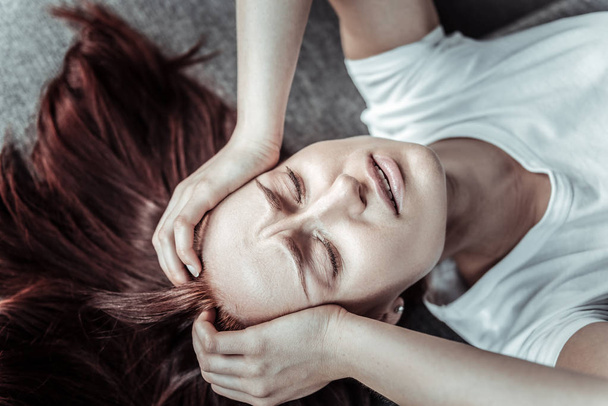 Worried female person suffering pain - Фото, зображення