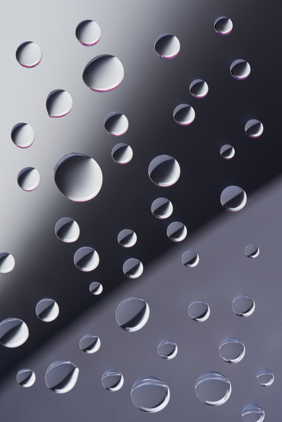 close-up view of transparent calm dew drops on grey background     - Photo, Image